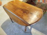 a small table with a wooden top on a floor