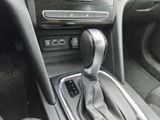the interior of a car with a manual gear box and a shift button