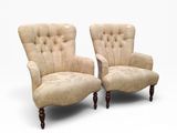pair of upholstered armchairs with tufted upholstered arms