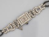 a close up of a wrist watch with diamonds on it