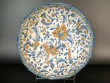 a blue and white plate with a floral design on it