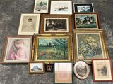 a lot of framed pictures on the floor of this room