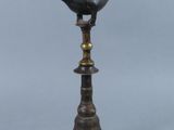 an old bronze lamp with a bird on top of it