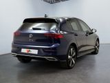the rear of a blue volkswagen e - pace parked in a showroom