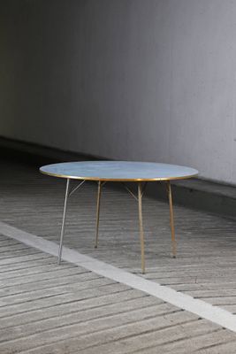 une table bleue posée sur un parquet dans une pièce