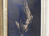painting of a dead bird in a gold frame on a wall