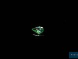 a close up of a green diamond on a black background