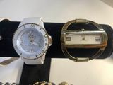 two watches and a bracelet on display in a store