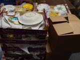 a stack of boxes with plates and bowls on top of it