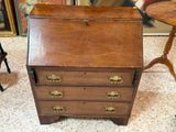 a small wooden desk with a drawer on top of it