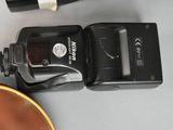 a camera and a bottle of wine on a table
