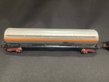 an orange and white train car sitting on top of a black table