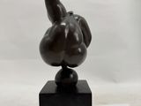 an image of a sculpture of a bird on top of a wooden block