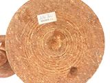 a brown plate with a label on it sitting on a white surface
