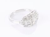 a close up of a diamond ring on a white surface