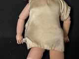 a small doll that is sitting on a black surface