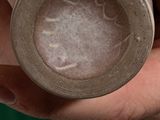 a person holding a small cup in their hand
