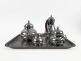 a silver tray with a silver tea set on it