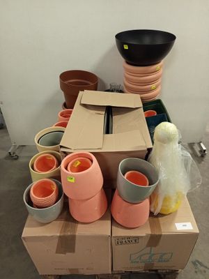 a pile of pots sitting on top of a cardboard box