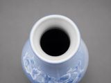 a blue and white vase sitting on a table