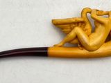 a figurine of a man sitting on a pipe