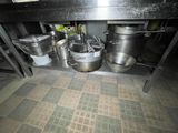many pots and pans that are sitting on the floor