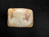 an antique carved ivory cameo of a woman and child