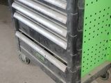 a laptop computer sitting on top of a metal cart