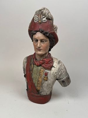statue of a bust of a man wearing a red hat and scarf