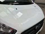 a close up of a white car parked in a parking lot