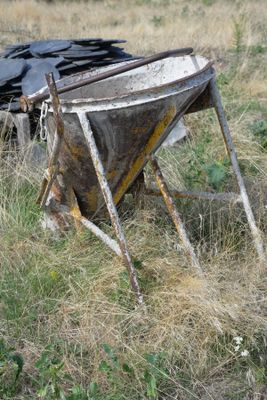 an old boat that is sitting in the grass