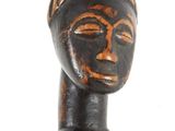 an image of a wooden figurine of a woman with a hat on