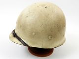 a close up of a helmet on a wooden base on a white background