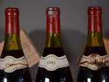 three bottles of wine that are sitting on a table