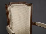 an old chair with a wooden frame and upholstered upholstered seat