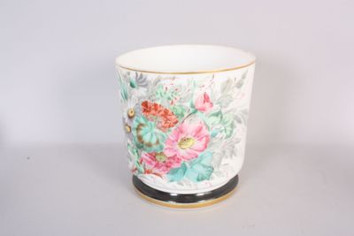 a white cup with a floral design on it