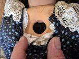 a person holding a doll that has a hole in it