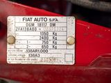 a close up of a sign on a red motorcycle