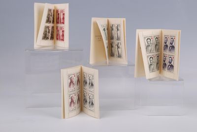 four small books are stacked on top of each other on a table