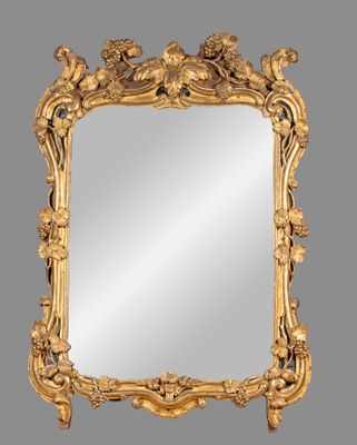a gold framed mirror with a floral design on it