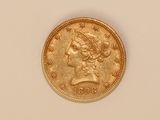 a close up of a gold coin on a white surface
