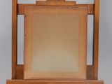 an old wooden easel with a painting on top of it