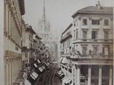 a black and white photo of a street in a city