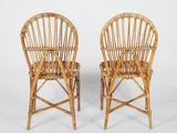 pair of wicker chairs on white background with white backdrop