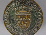 a close up of a gold coin with a crown on it