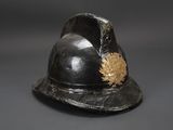 a black helmet with a gold leaf on it