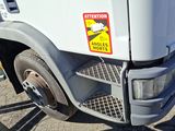 a close up of the front of a truck with a warning sticker on it
