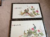 two framed pictures of birds and flowers on the floor