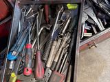 many tools in a tool box on the floor
