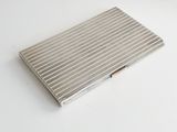 an image of a silver cigarette case sitting on a white surface
